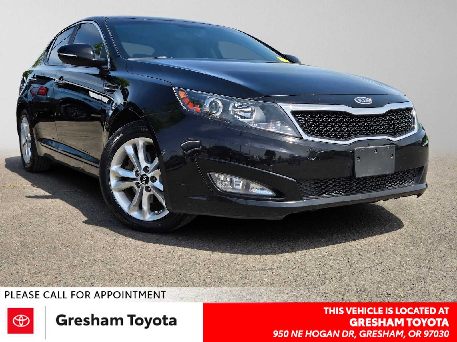 2011 Kia Optima EX in Ebony Black — front three-quarter view